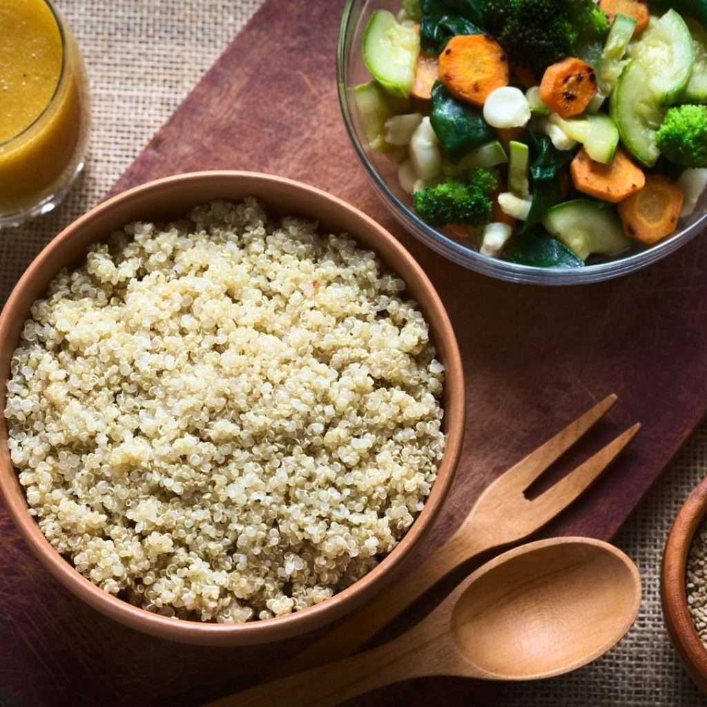 quinoa in a small bowl with a small bowl of vegetables next to it