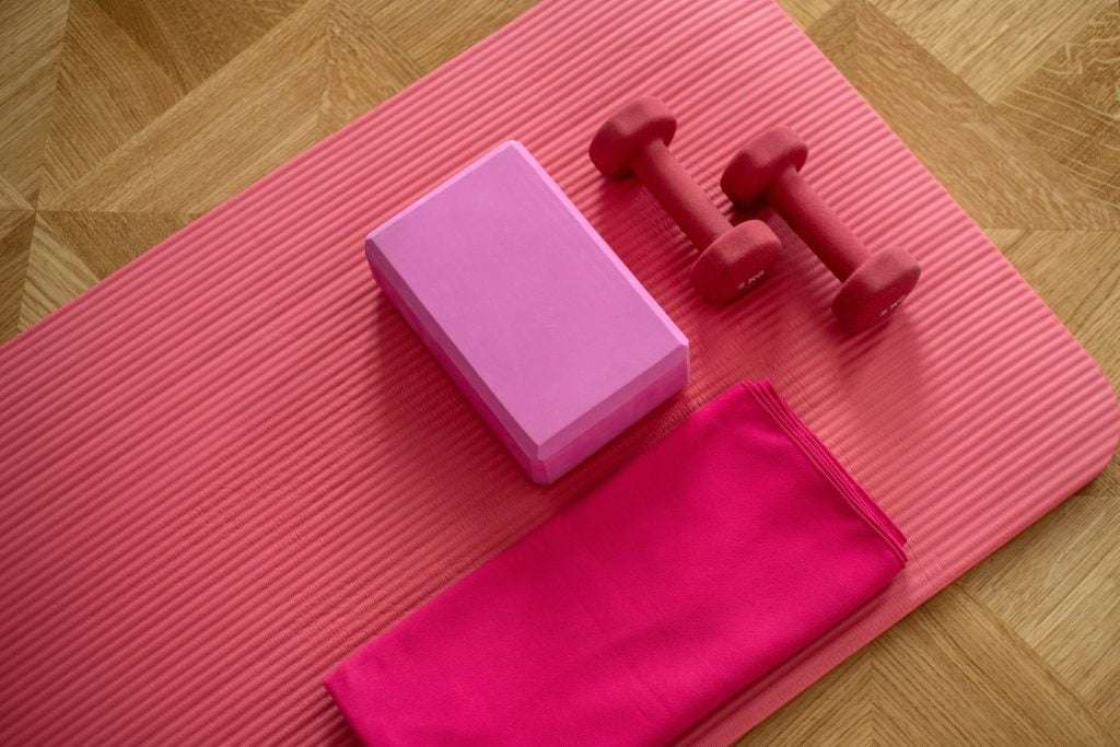 rose gym mat with weights and head rests on top of it