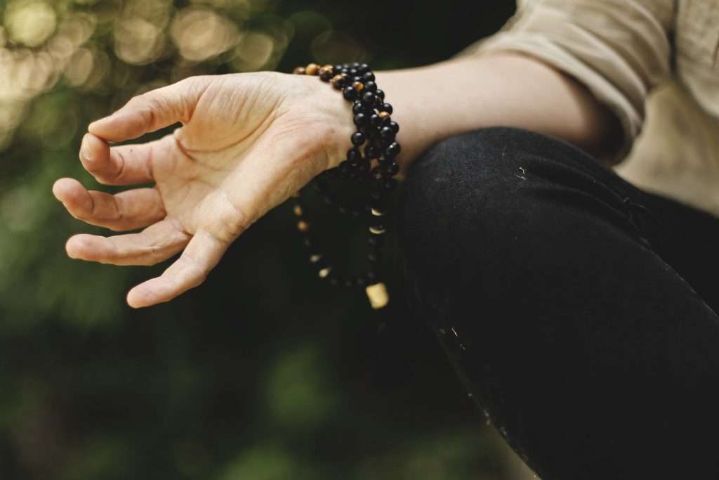 person making a meditation symbol with their hand