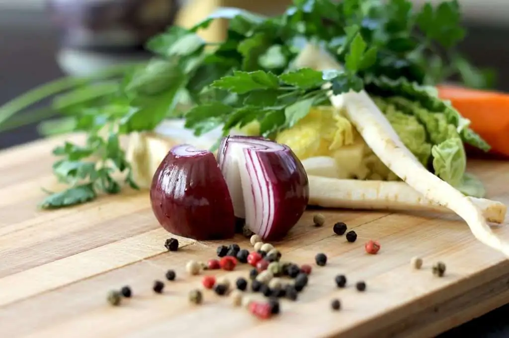 sliced onion with other vegetables on a chopping board