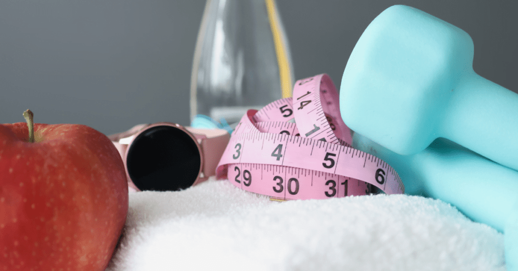 weight loss tools laying on a towel with fruit beside it