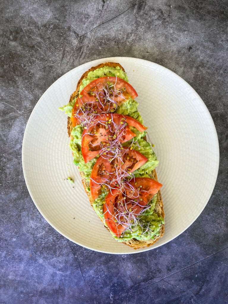 avocado toast with tomato and onion on a plate